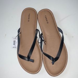 Torrid flat sandals. New with tag. Size 11.5 wide width. Slim black straps.